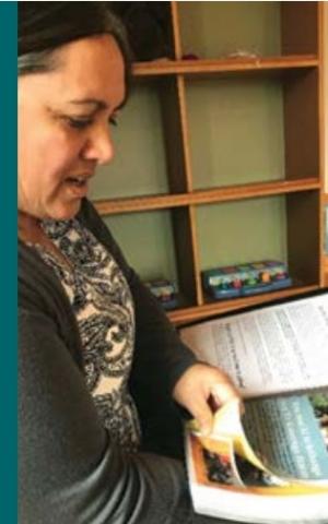 A woman reads a planning book.