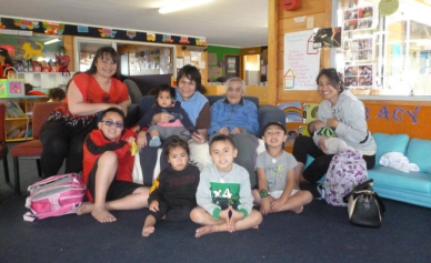 Four adults and 6 children sitting together - these people cover four generations.