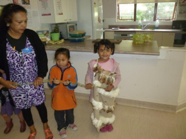 A women and two young children preparing to pōwhiri manuhiri